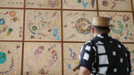 Hormazd Narwiella as seen from behind, standing in front of his mural at the 澳洲幸运5计划预测官网 Society and viewing it.